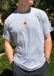 Rooted Swim Sunset Embroidered Tee Shirt in Heather Gray. Includes red sun and dark green wave design.