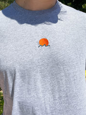 Rooted Swim Sunset Embroidered Tee Shirt in Heather Gray. Includes red sun and dark green wave design.
