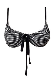 Black and white checkered bikini top with straps on a white background