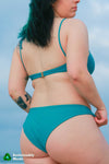 Rooted Swim Classic Bikini Bottom in the color Calypso, a medium coverage bottom. Displaying a photo of the back of the bottoms