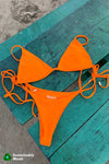 Adjustable, triangle style bikini top in bright poppy orange by Rooted Swim